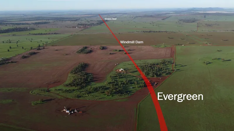 Evergreen drone photo looking south at diamond core drill rig in the foreground towards other drilled target areas