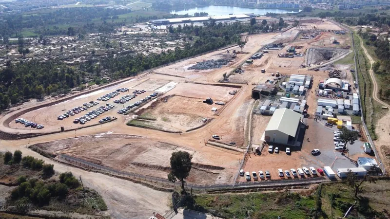 MAGE 1: aerial VIEW OF QALA shallows showing THE decline portal, workshop, SITE offices AND surface infrastructure works